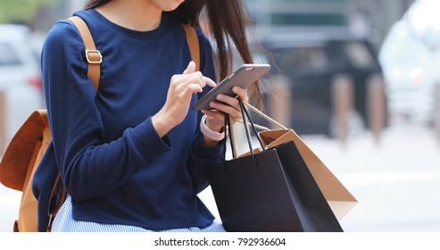 Woman Look At Mobile Phone And Holding Shopping Bag 
