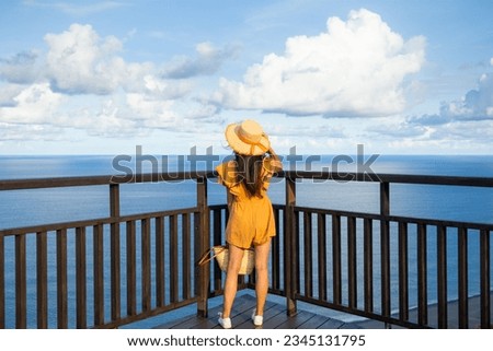 Woman look at the sea in sunny day