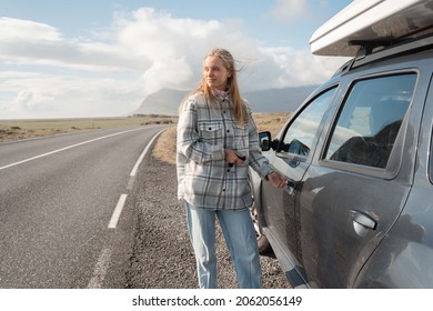 Woman Looking At The Amazing Views Of Iceland While Opening Door Of Her Car