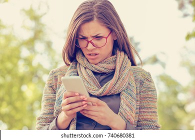 Woman looking angry at the phone  - Shutterstock ID 740680381