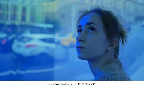 Woman Looking Around And Watching Video Presentation On Large Display Wall At Futuristic Technology Exhibition