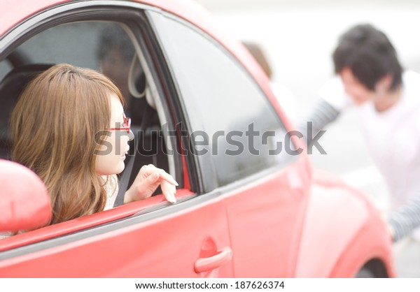 woman looking back from car\
window