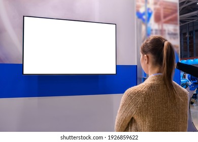 Woman Looking At Blank Digital Interactive White Display Wall At Exhibition Or Museum With Futuristic Scifi Interior. White Screen, Mock Up, Future, Copyspace, Template, Technology Concept