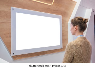 Woman Looking At Blank Digital Interactive White Display Wall At Exhibition Or Museum With Futuristic Scifi Interior. White Screen, Mock Up, Future, Copyspace, Template, Technology Concept