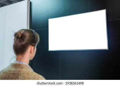 Woman Looking At Blank Digital Interactive White Display Wall At Exhibition Or Museum With Futuristic Scifi Interior. White Screen, Mock Up, Future, Copyspace, Template, Technology Concept