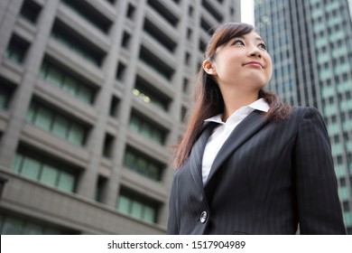 A Woman Looking Up At A Building