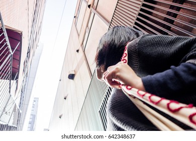 Woman looking up at buildings