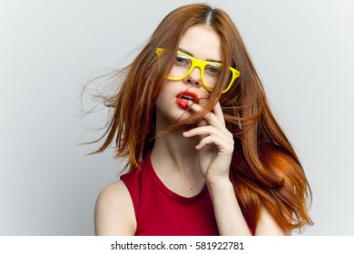 Woman looking at the camera on a light background
