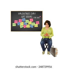 Woman Looking Up From Cell Phone Briefcase Euros Overflowing Behind Blackboard With Valentines Day Gift Ideas For Her (box Of Chocolate, Engagement Ring, Spa, Trip, Lingerie, Dinner, Movie And More) 