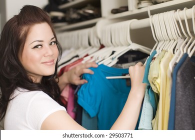 Woman Looking At Clothes In A Closet