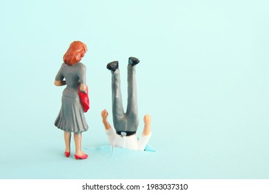 woman looking at clumsy man. funny concept of married couple or romantic relationship