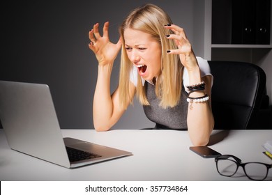 Woman Looking At Computer And Going Crazy 