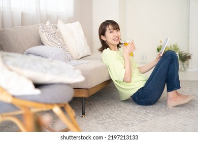 Woman Looking At Computer While Drinking Beer