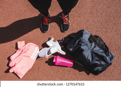 Woman Looking Down At Her Athletic Gear