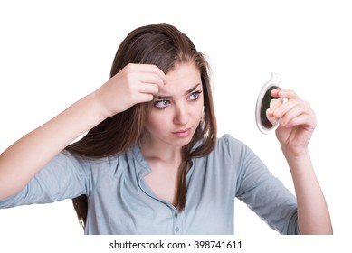 Woman Looking At The First Grey Hair On Her Scalp