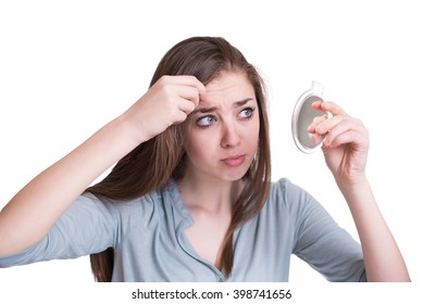 Woman Looking At The First Grey Hair On Her Scalp