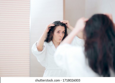 Woman Looking For Gray Hair In The Mirror. Funny Girl Scared Of Premature Aging Signs
