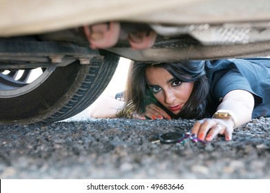 Woman Looking For Her Car Key Under The Car