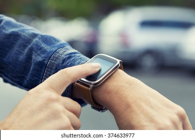 Woman looking for her car with smart-watch in parking car - Powered by Shutterstock