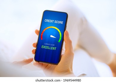 Woman looking at her credit score test on mobile phone showing excellent score - Shutterstock ID 1969544980