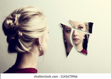 Woman Looking At Her Face In Three Shards Of Broken Mirror Pieces