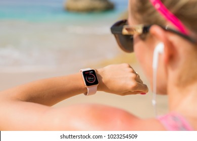 Woman looking at her heart rate data on smartwatch - Powered by Shutterstock