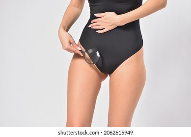 Woman Looking Her Intimate Bikini Zone With A Magnifying Glass