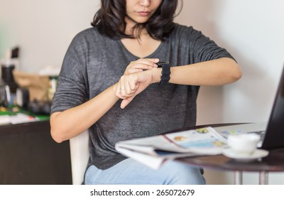 Woman Looking At Her Smart Watch