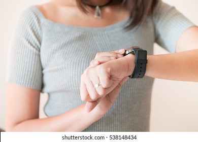 Woman Looking At Her Smart Watch