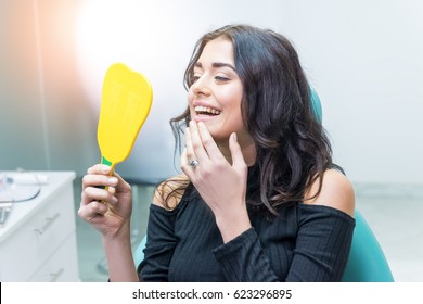 Woman Looking At Her Teeth. Smiling Lady At Dentist Office. Smile As A Masterpiece.