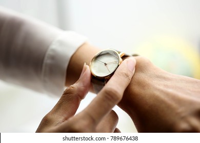 Woman Looking At Her Watch.