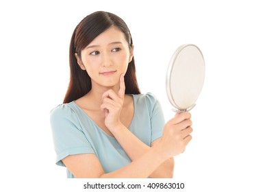 Woman Looking At Herself In A Hand Mirror