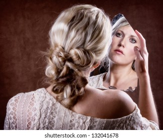 Woman Looking Into A Broken Mirror With A Sad Look,  Back Of Head Showing