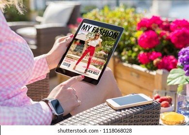 Woman Looking At Magazine Cover On Digital Tablet