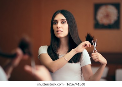 
Woman Looking in Mirror Cutting Split Hair Ends. Girl changing looks giving herself a with DIY cut 
