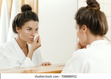 Woman Is Looking In To The Mirror And Removing Makeup With A Cotton Pad