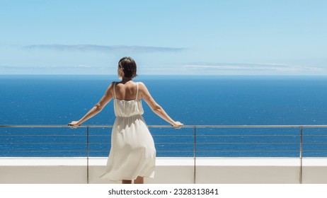 Woman looking at ocean from balcony - Powered by Shutterstock