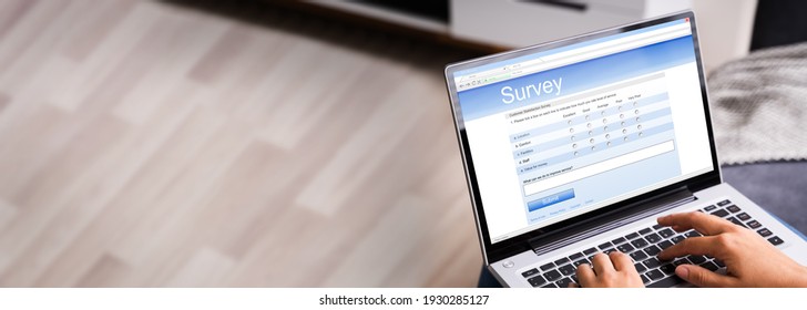 Woman Looking At Online Computer Survey Or Feedback