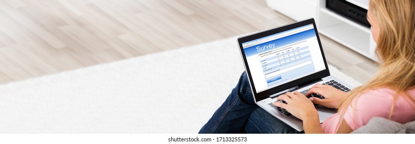 Woman Looking At Online Survey On Computer Screen