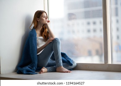 woman looking out the window and window sill blue plaid                          - Shutterstock ID 1194164527