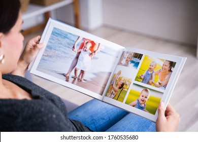 Woman Looking At Photo Album Or Photobook