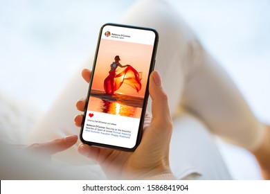 Woman looking at photo on social media app, person names on screen are all made up - Shutterstock ID 1586841904