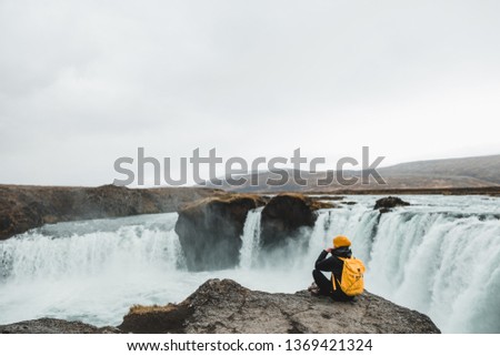 woman looking at picturesque Godafoss waterfall, Iceland. Nordic nature