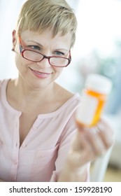 Woman Looking At Pill Bottle