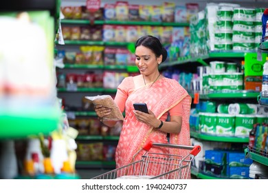 Woman Looking Product Information At Supermarket