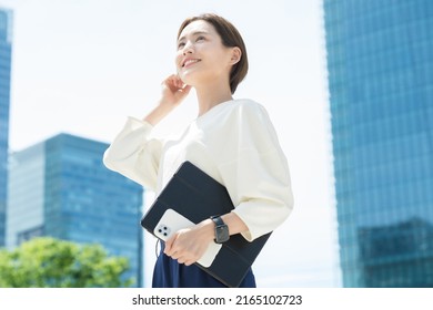 Woman looking up at the sky (business woman) - Shutterstock ID 2165102723