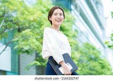 Woman looking up at the sky (business woman) - Shutterstock ID 2165102747
