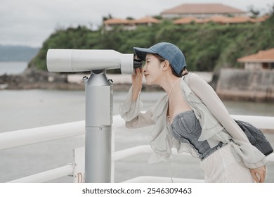 Woman looking at skyline and through Coin operated binoculars or telescope. - Powered by Shutterstock