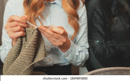 Woman looking at the tag on the clothes before loading clothes into washing machine.