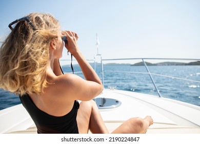 Woman Looking Through Binoculars On Boat